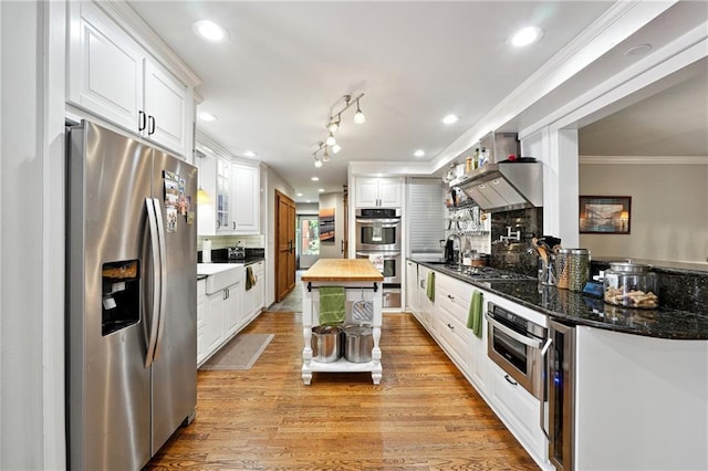1438 Salem Dr, Alpharetta, GA 30009 - kitchen with stainless steel appliances, wooden counters, ornamental molding, white cabinets, and light wood finished floors