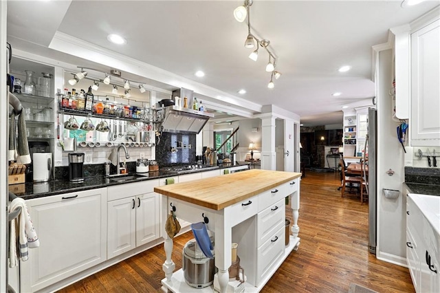 1438 Salem Dr, Alpharetta, GA 30009 - kitchen featuring butcher block counters, stainless steel gas cooktop, white cabinetry, dark wood-style floors, and ornate columns