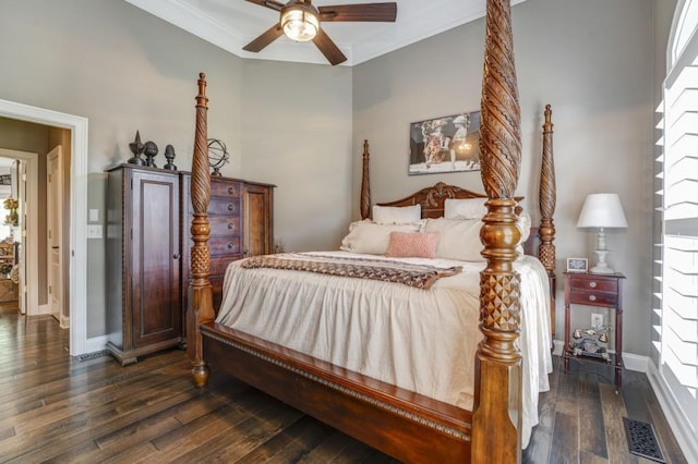 bedroom with crown molding, ceiling fan, and dark hardwood / wood-style flooring