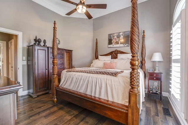 bedroom featuring ceiling fan, ornamental molding, and dark hardwood / wood-style floors