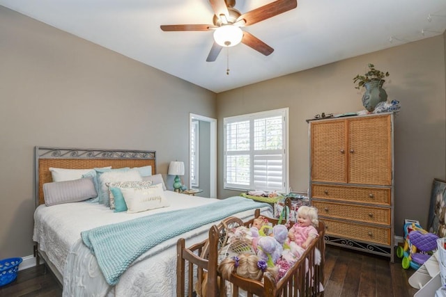 bedroom with ceiling fan and dark hardwood / wood-style flooring