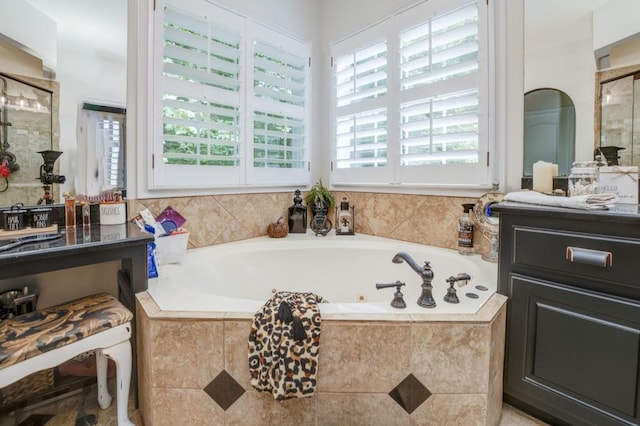 bathroom featuring shower with separate bathtub, plenty of natural light, and vanity