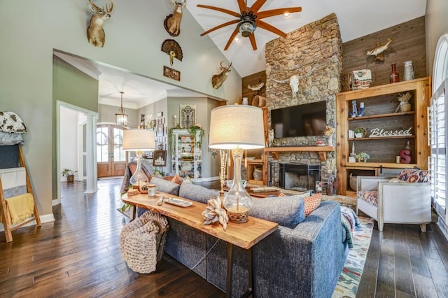 living room with dark wood-type flooring, ceiling fan, high vaulted ceiling, and decorative columns