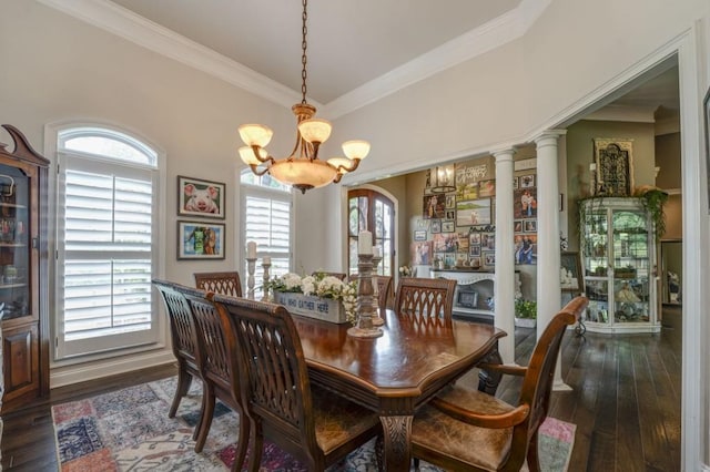 dining room with dark wood-type flooring, ornamental molding, and a notable chandelier