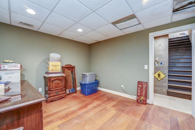 miscellaneous room featuring a paneled ceiling and hardwood / wood-style floors