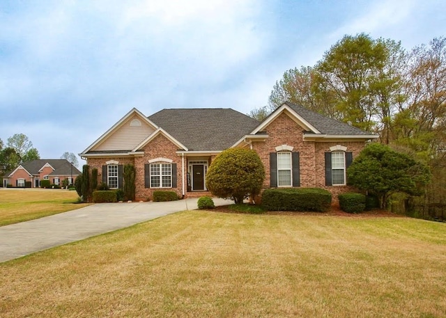 traditional-style house with brick siding and a front yard