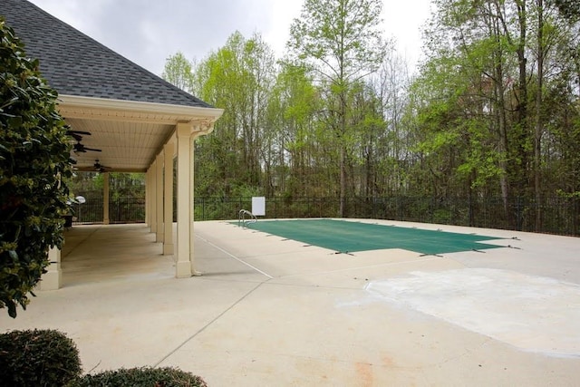 view of pool with a ceiling fan, a patio, and fence