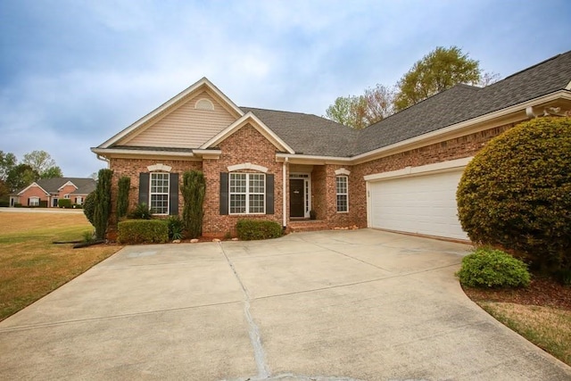 view of front of home with brick siding, concrete driveway, a garage, and a front lawn