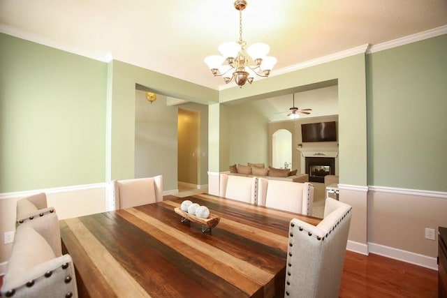 dining area featuring a chandelier, a ceiling fan, baseboards, dark wood-style flooring, and a fireplace