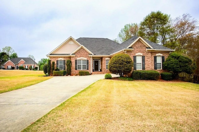118 Jasmine Way, Carrollton, GA 30180 - view of front of house featuring brick siding, a front yard, and driveway