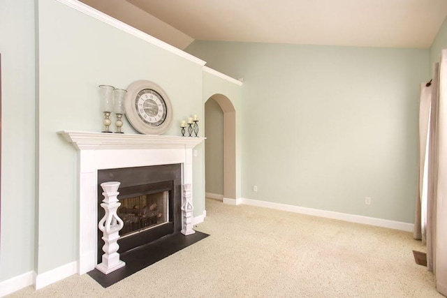 living room featuring carpet floors, baseboards, vaulted ceiling, and arched walkways