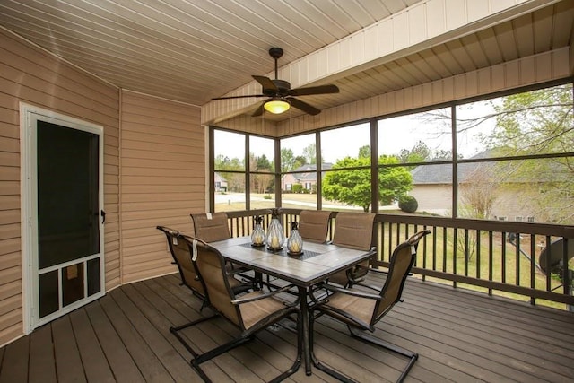 sunroom / solarium featuring outdoor dining area and ceiling fan