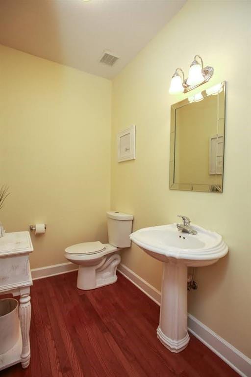 118 Jasmine Way, Carrollton, GA 30180 - bathroom with wood finished floors, toilet, baseboards, and a sink