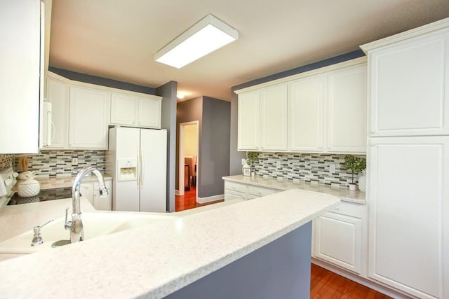 kitchen featuring white appliances, light countertops, and decorative backsplash
