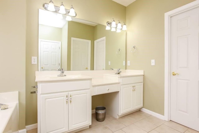 bathroom with tile patterned flooring, double vanity, a bathtub, and baseboards