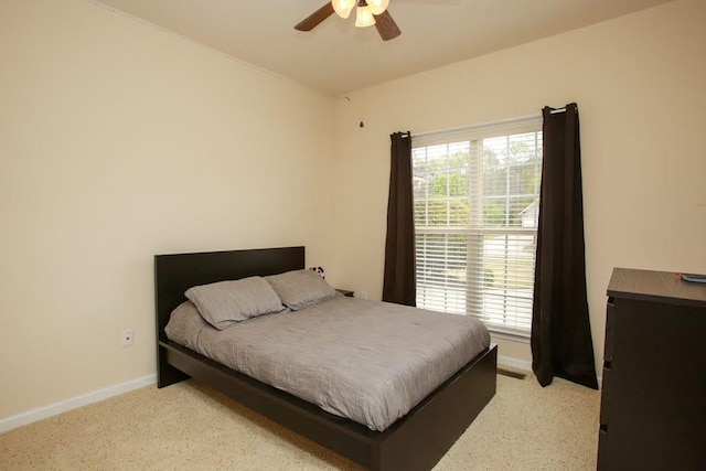 bedroom featuring baseboards, ceiling fan, and carpet floors