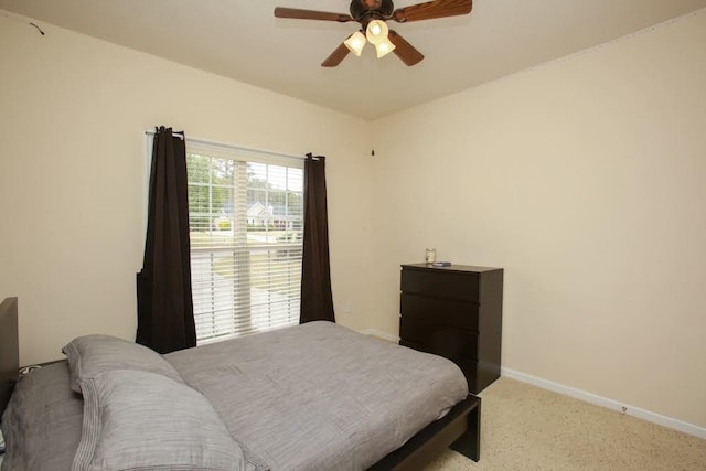bedroom with light carpet, baseboards, and ceiling fan