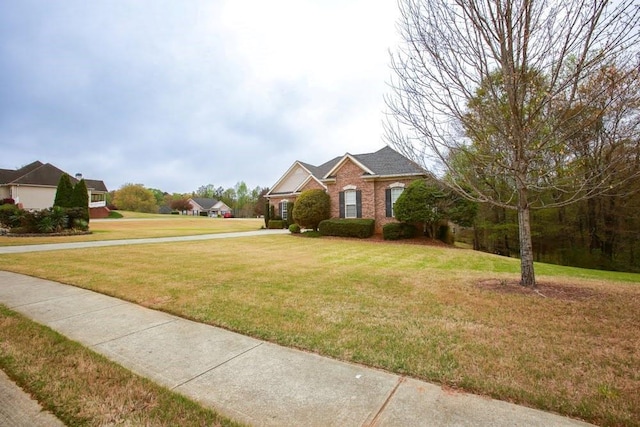 traditional-style home with a front lawn and brick siding