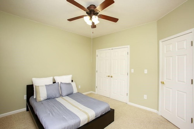 bedroom with light colored carpet, baseboards, and a closet
