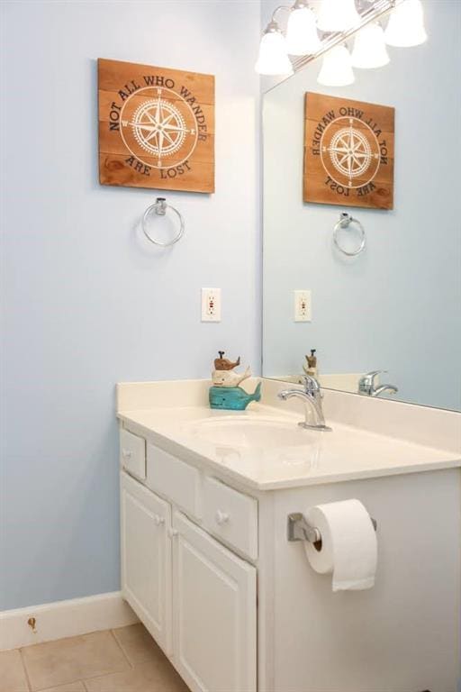 bathroom with tile patterned flooring, vanity, and baseboards