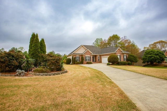 single story home with driveway, a front lawn, an attached garage, and brick siding
