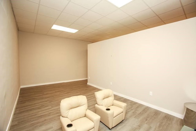 sitting room with light wood-type flooring and baseboards