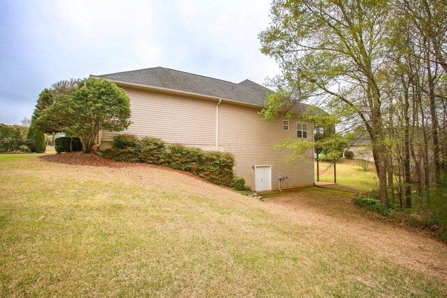 view of side of home featuring a lawn
