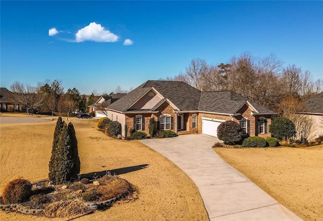 view of front of house with a garage, brick siding, and driveway