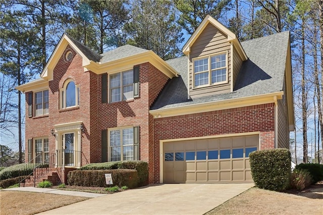 view of front facade with brick siding, roof with shingles, and concrete driveway