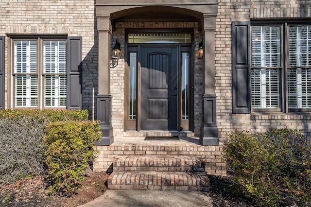 entrance to property with brick siding