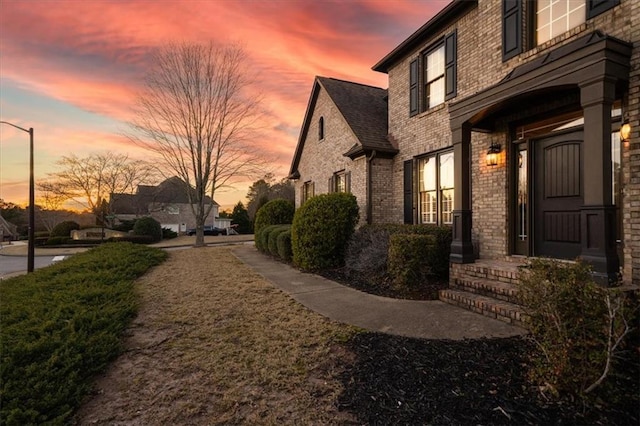 view of property exterior featuring brick siding