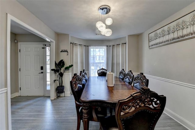 dining area featuring a chandelier and wood-type flooring