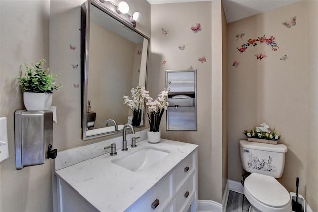 bathroom featuring vanity and toilet