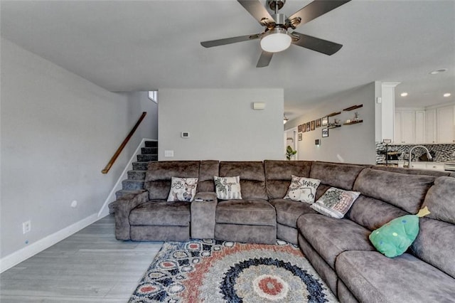 living room featuring ceiling fan and light hardwood / wood-style floors