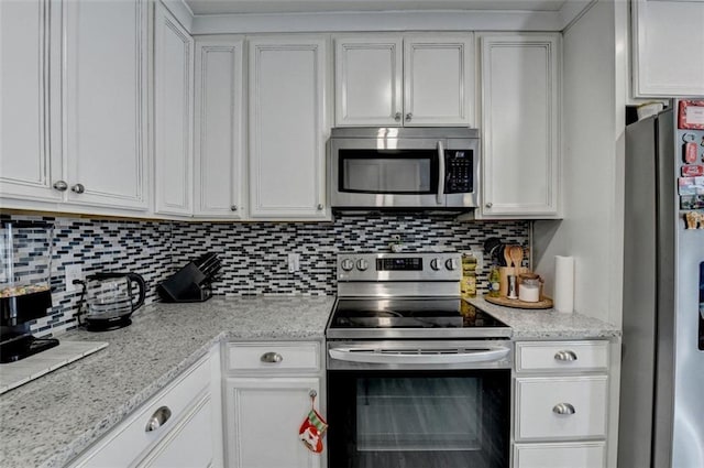 kitchen with decorative backsplash, white cabinetry, and stainless steel appliances