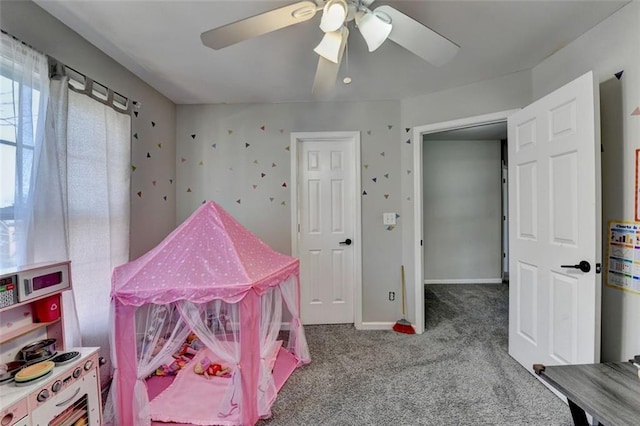 playroom featuring ceiling fan and carpet floors