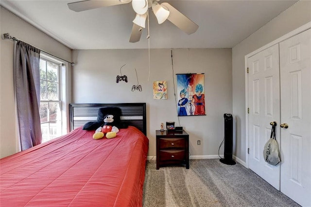 bedroom with ceiling fan, carpet floors, and a closet