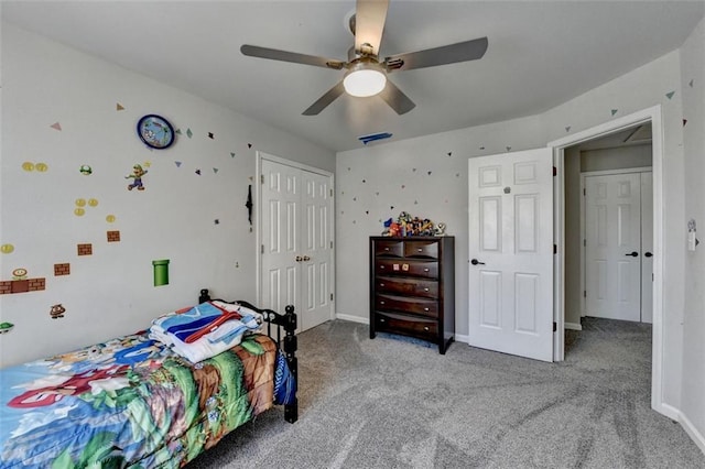 carpeted bedroom with ceiling fan and a closet