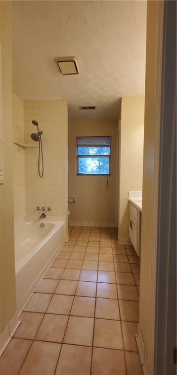 bathroom with a textured ceiling, shower / bathing tub combination, tile patterned flooring, baseboards, and vanity