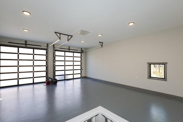 garage with recessed lighting, visible vents, and baseboards