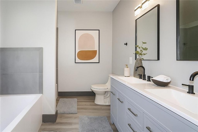 221 Dragonfly Cv, Toccoa, GA 30577 - bathroom featuring a bath, double vanity, and wood finished floors