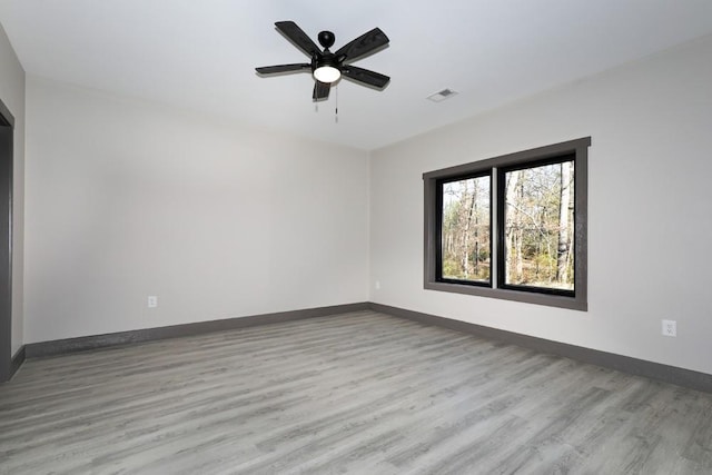 empty room with light wood-type flooring and ceiling fan