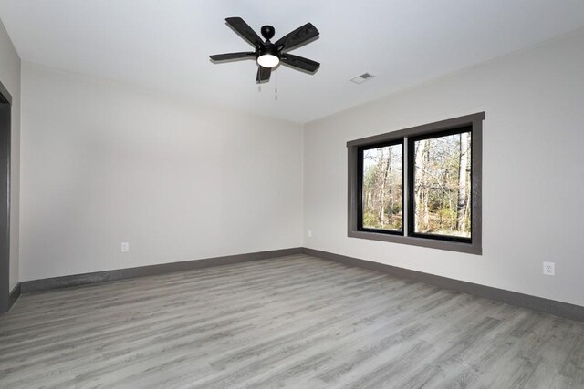 spare room featuring ceiling fan and light hardwood / wood-style flooring