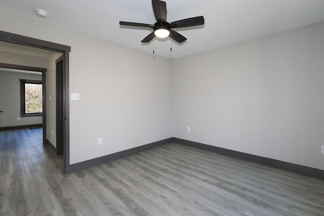 unfurnished room with hardwood / wood-style floors and ceiling fan