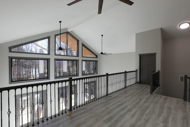 interior space with hardwood / wood-style floors, vaulted ceiling with beams, and ceiling fan