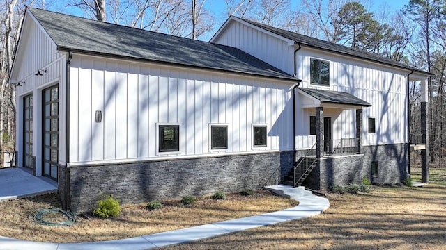 view of property exterior with stone siding and board and batten siding