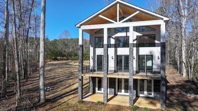 back of property featuring a sunroom and a patio