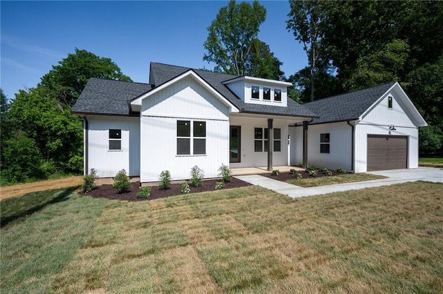 554 Mcdaniel Station Rd SW, Calhoun, GA 30701 - modern farmhouse featuring a garage, covered porch, and a front yard