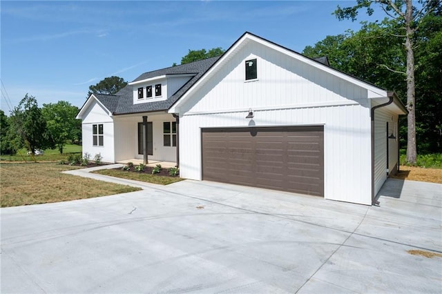 554 Mcdaniel Station Rd SW, Calhoun, GA 30701 - modern farmhouse with a garage, concrete driveway, covered porch, and roof with shingles