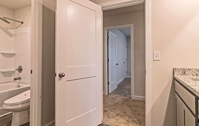full bathroom featuring vanity, bathtub / shower combination, and toilet